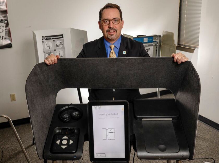 Dean Logan, 52, the registrar-recorder/county clerk for Los Angeles County, stands with a prototype ballot marking device like tho ones that will be introduced during the presidential primary in March.