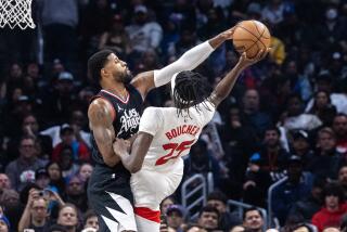 LOS ANGELES, CA - JANUARY 10, 2024: LA Clippers forward Paul George (13) stuffs Toronto Raptors forward Chris Boucher (25) in the first half at Crypto.com Arena on January 10, 2024 in Los Angeles, California.(Gina Ferazzi / Los Angeles Times)