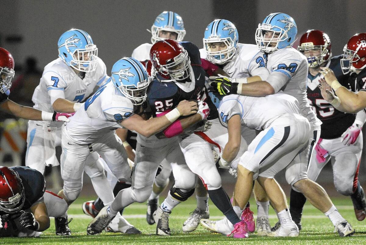 Karl Donovan (33), shown here in 2014 as part of a swarm of tacklers, is the lone Corona del Mar representative in the Orange County All-Star football game on July 8 at Orange Coast College.