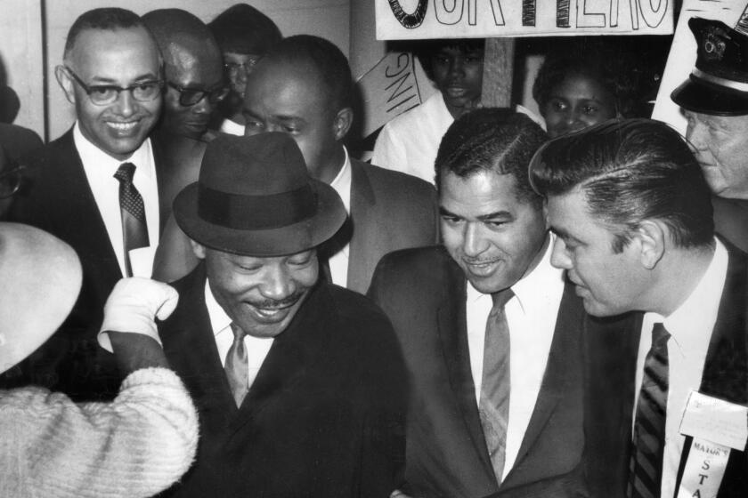 Feb. 24, 1965 -- Rev. Martin Luther King receives warm welcome on his arrival in Los Angeles. Photo by: Jack Carrick / LA Times.