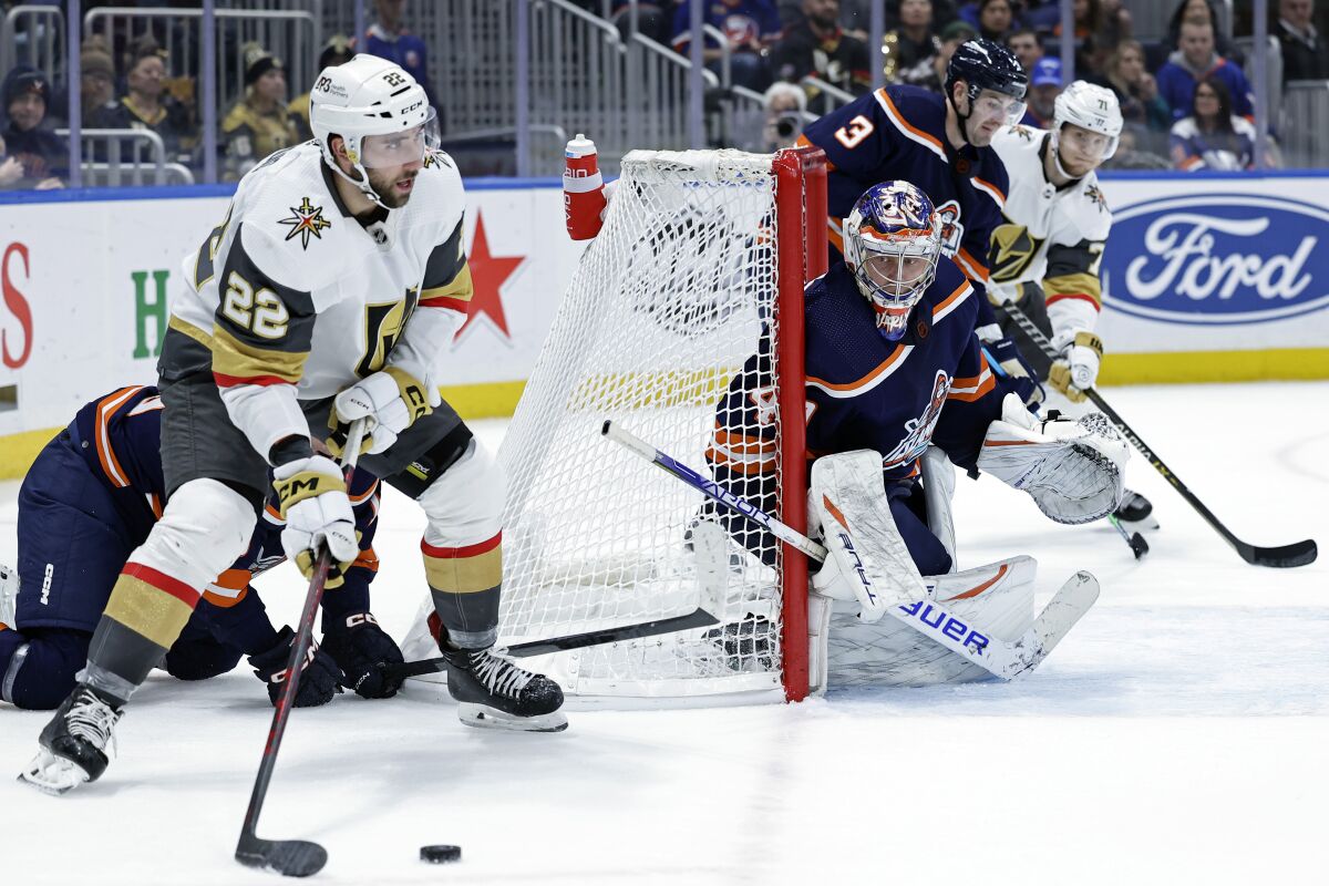 New York Islanders goaltender Semyon Varlamov defends against Vegas Golden Knights right wing Michael Amadio (22) in the third period of an NHL hockey game Saturday, Jan. 28, 2023, in Elmont, N.Y. The Islanders won 2-1 in overtime. (AP Photo/Adam Hunger)