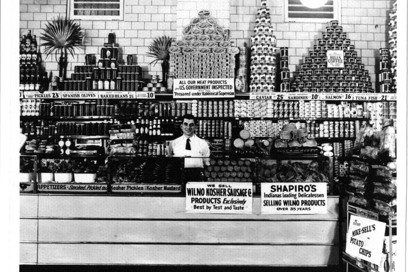Second-generation owner Abe Shapiro stands behind the counter of Shapiro’s Delicatessen in Indianapolis circa 1932. 