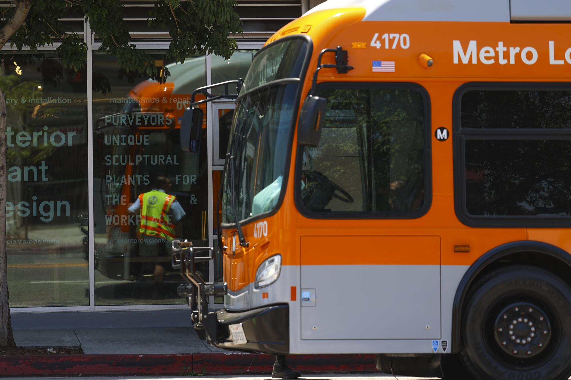 The front end of an orange Metro bus.