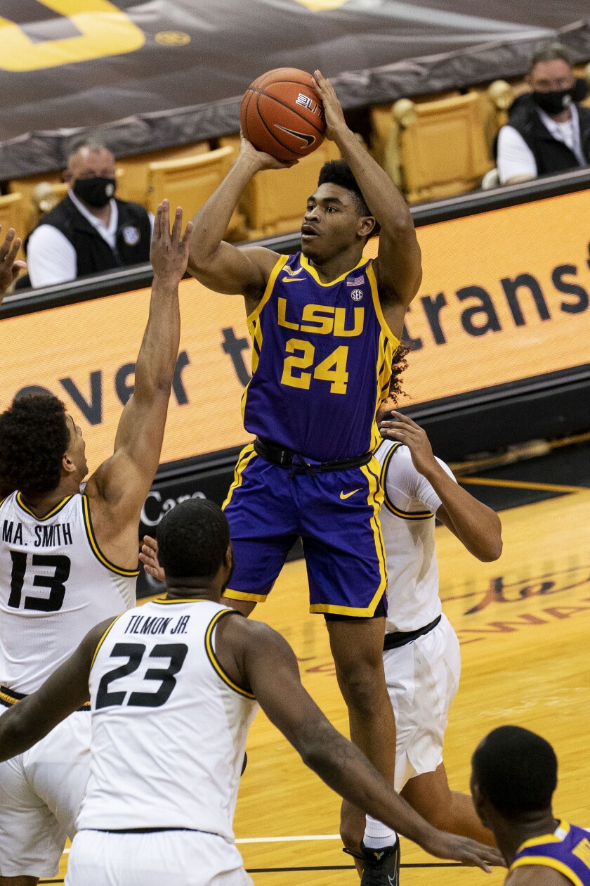 LSU's Cameron Thomas, top, shoots over Missouri's Mark Smith, left, and Jeremiah Tilmon, right, during the first half of an NCAA college basketball game Saturday, March 6, 2021, in Columbia, Mo. (AP Photo/L.G. Patterson)