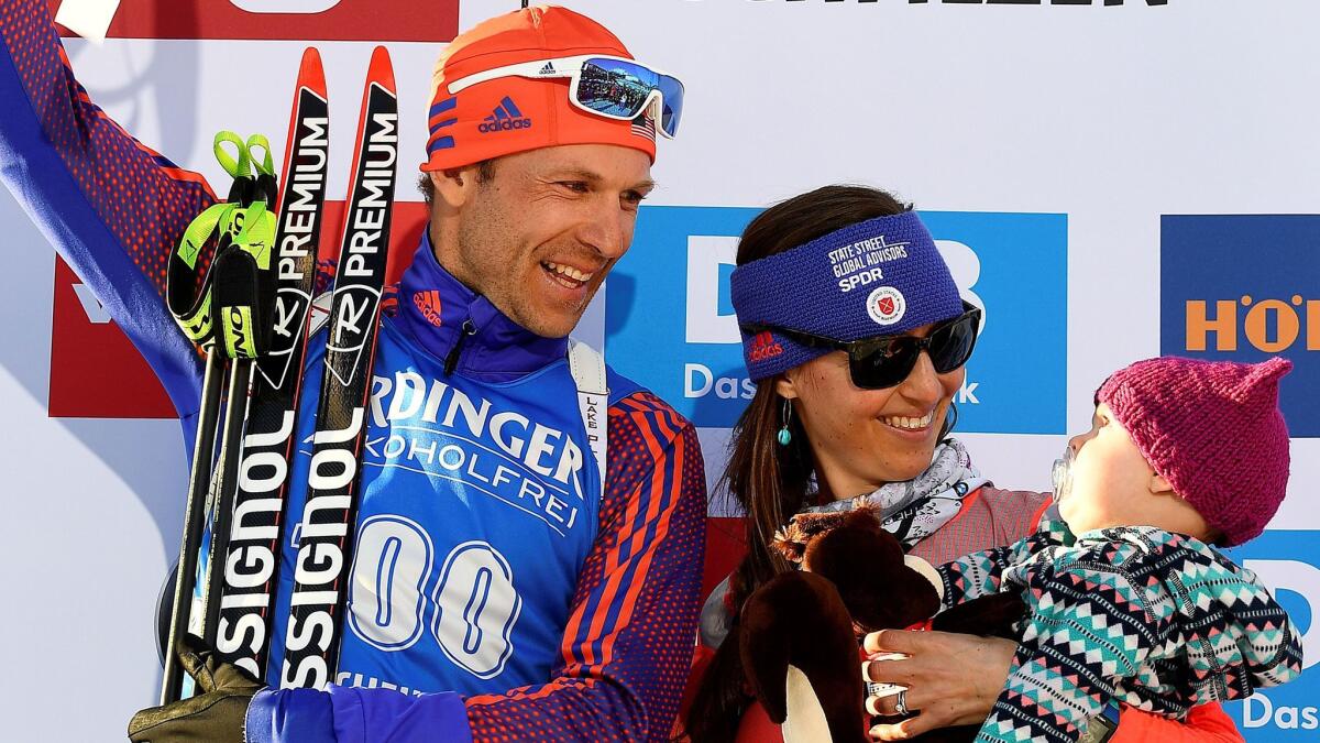 Lowell Bailey poses on the podium with wife, Erika, and daughter Ophelia after becoming the first world champion in U.S. biathlon history on Feb. 16, 2017, in Hochfilzen, Austria.