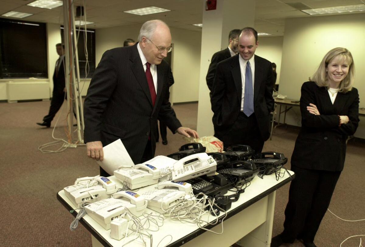 Liz Cheney and her husband, Phil Perry, with former Vice President Dick Cheney shortly after his election in 2000. A flap over Perry's voter registration is the latest controversy to dog Liz Cheney's Senate campaign.