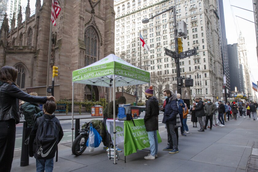 People line up for coronavirus tests on Wall Street in New York on Thursday.