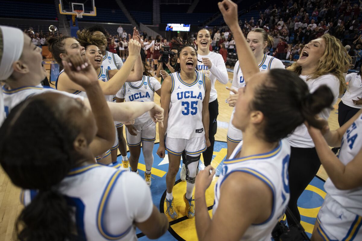 UCLA players celebrate after defeating Oklahoma in a second-round college basketball game in the NCAA Tournament, Monday, March 20, 2023, in Los Angeles. UCLA won, 82-73. (AP Photo/Kyusung Gong)