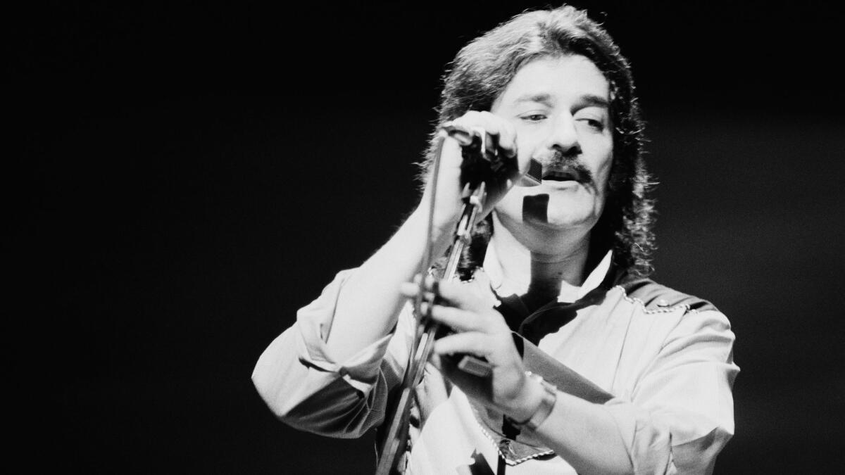 Singer and flautist Ray Thomas performing with English rock group Moody Blues in 1981.