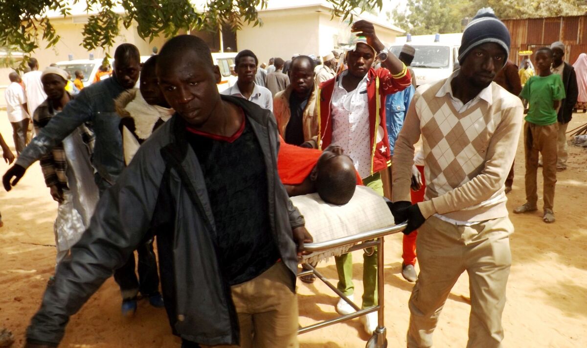 A man injured in a suicide blast is transported at the General Hospital in the northeast Nigerian town of Potiskum on Jan. 12.