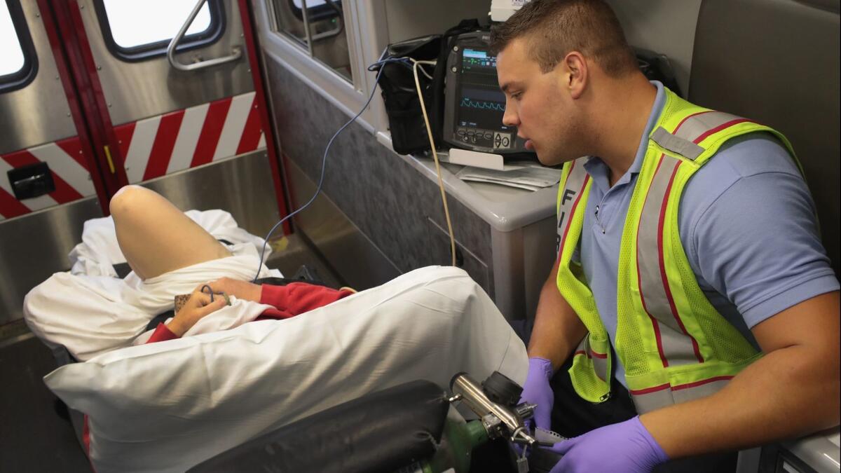 A firefighter treats an opioid overdose victim in Rockford, Ill. A new study projects that if present trends continue, opioid overdose deaths in the U.S. will rise sharply in coming years.
