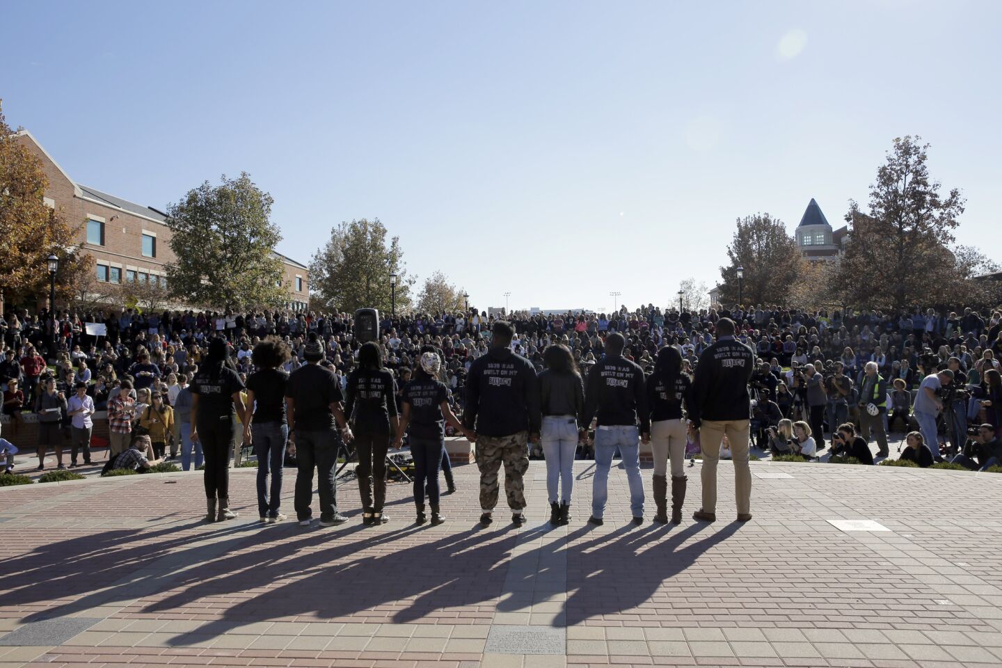 Members of the student protest group Concerned Student 1950 hold hands at the University of Missouri in Columbia, Mo., after the announcement that System President Tim Wolfe would resign. The football team and others on campus had been in open revolt over his handling of racial tensions at the school.