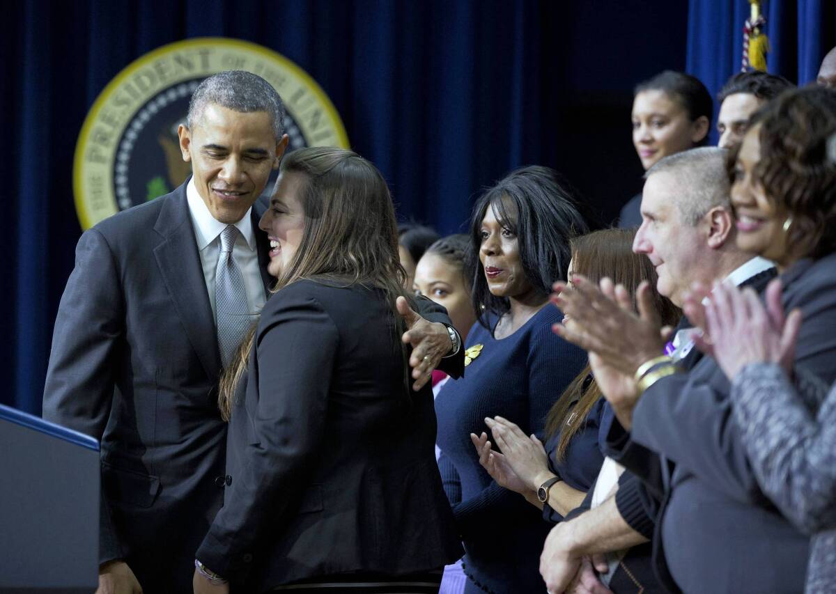 President Obama hugs Monica Weeks at an event in Washington promoting the Affordable Care Act. The law allowed her to remain on her parents' health plan while getting treatment for Crohn's disease.