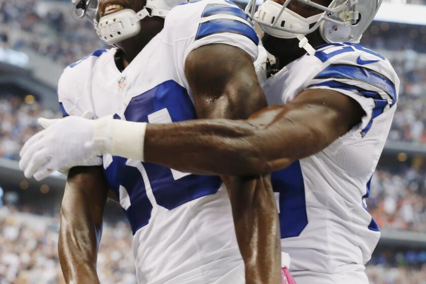 Dallas wide receiver Dez Bryant is congratulated by teammate DeMarco Murray after scoring a touchdown against the Denver Broncos in October 2013.