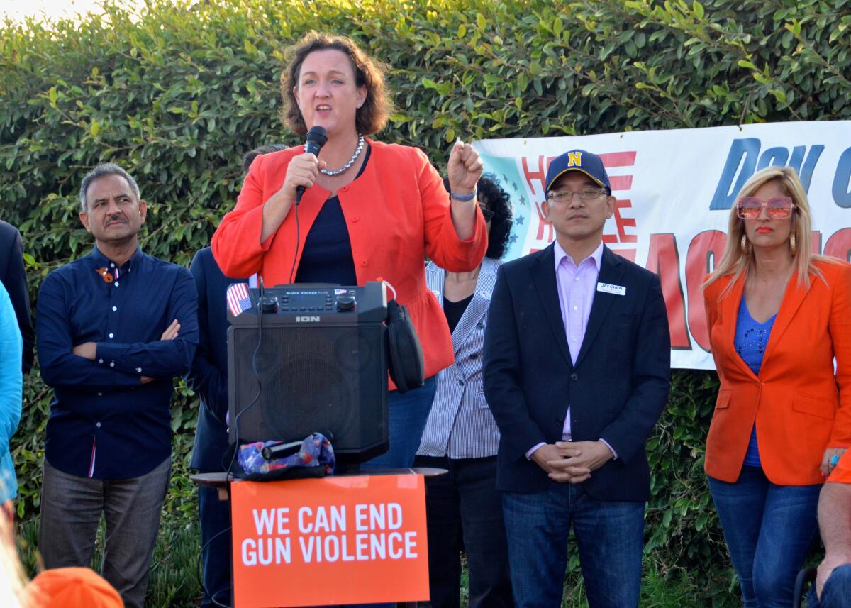 U.S. Rep. Katie Porter addresses the crowd during Stop Gun Violence rally held Saturday night at Eisenhower Park.
