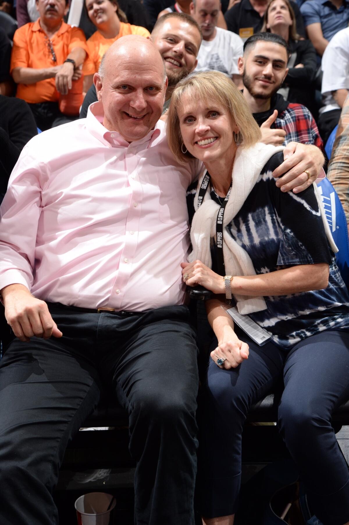 Steve and Connie Ballmer pose for a photo at their Staples Center courtside seats.