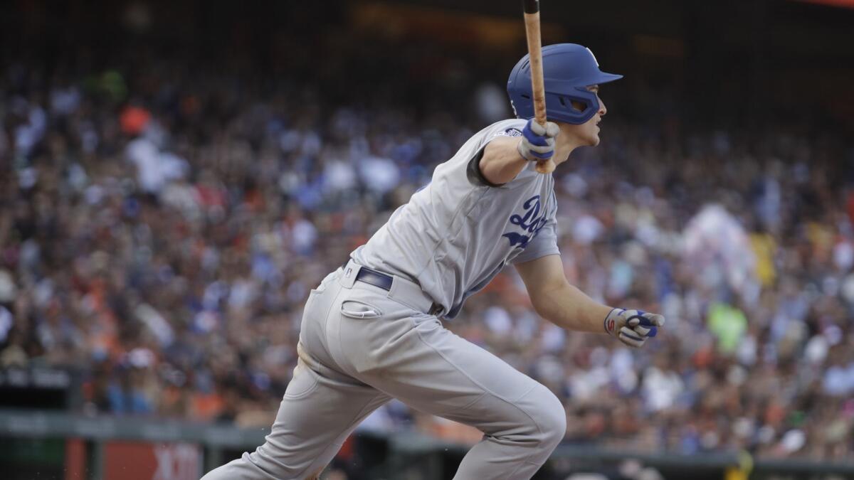 The Los Angeles Dodgers' Corey Seager hits an RBI double in the fifth inning June 8. Seager had three of his four hits and three of his four RBIs following intentional walks to Cody Bellinger.