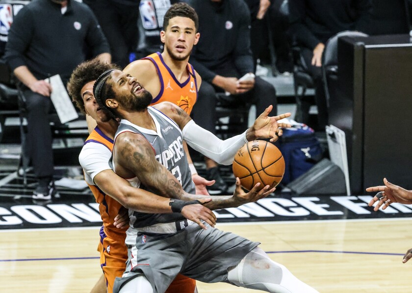 The Clippers' Paul George is fouled by the Phoenix Suns' Torrey Craig late in the third quarter June 26, 2021.