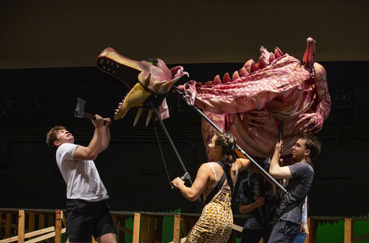Noah Doody, 18, left, rehearsing for his role as Shrek, runs through a scene with cast members and dragon puppeteers.
