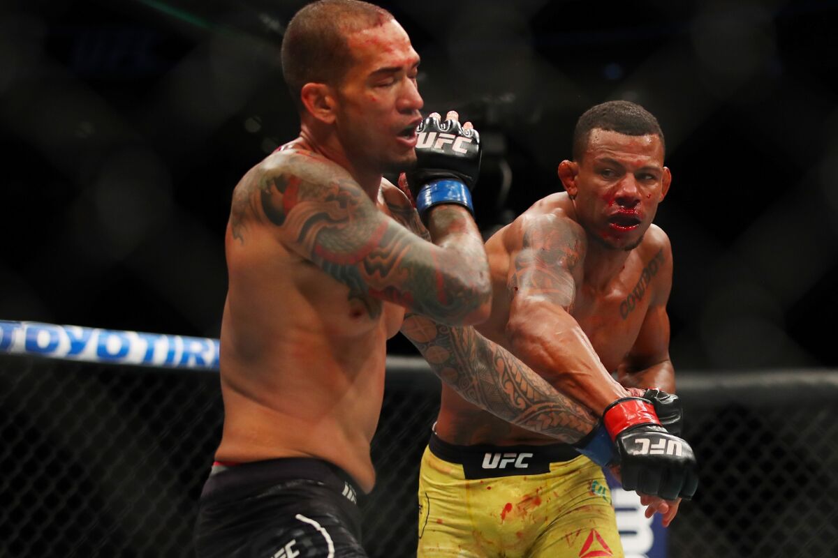 Alex Oliveira lands a big right against Yancy Medeiros during their bout at UFC 218.