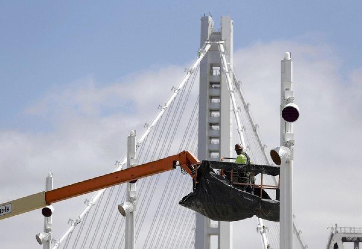 This photo taken Aug. 1, 2013, shows a worker on the troubled eastern span of the San Francisco-Oakland Bay Bridge in San Francisco. Officials are pressing ahead to open the span to traffic around Labor Day weekend.