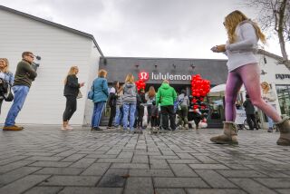 Customers wait in a line outside the new Lululemon store at One Paseo in Carmel Valley, that opened to customers for the first time on Black Friday, November 29, 2019 in San Diego, California.