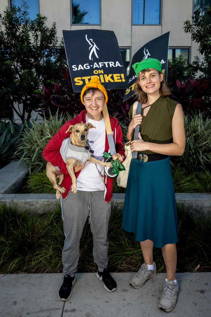 Cameron Laventure, right, as Link from "The Legend of Zelda" and Ari Fromm as Todd, with their dog as Mr. Peanutbutter, from "BoJack Horseman."