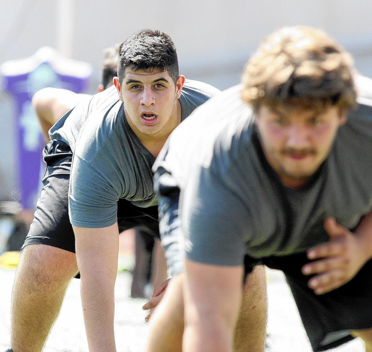 Mher Torrsian lines up in a drill for lineman at the first summer football practice at Hoover High School on Monday, June 9, 2014.