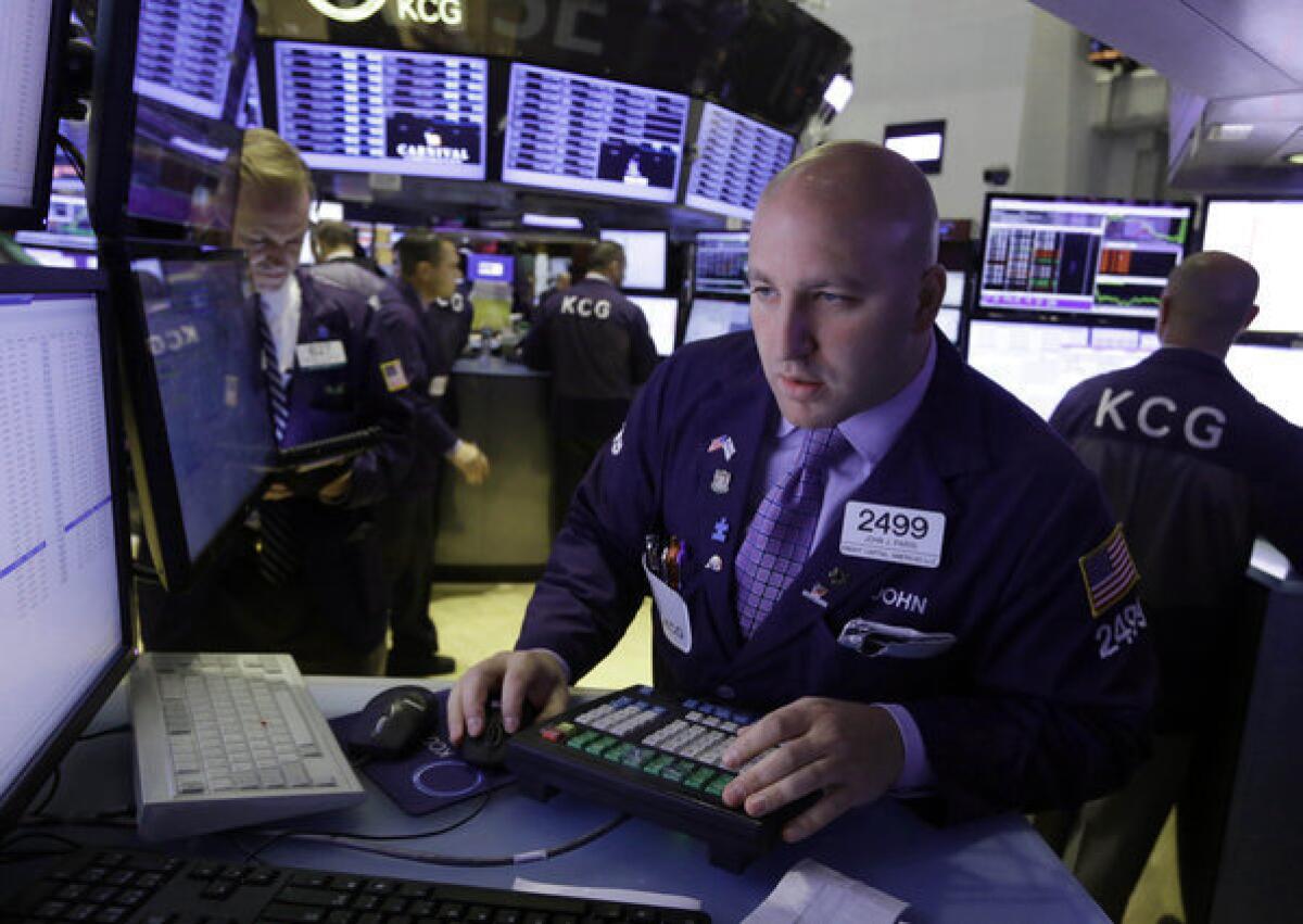 Specialist John Parisi works at his post on the floor of the New York Stock Exchange on Wednesday.