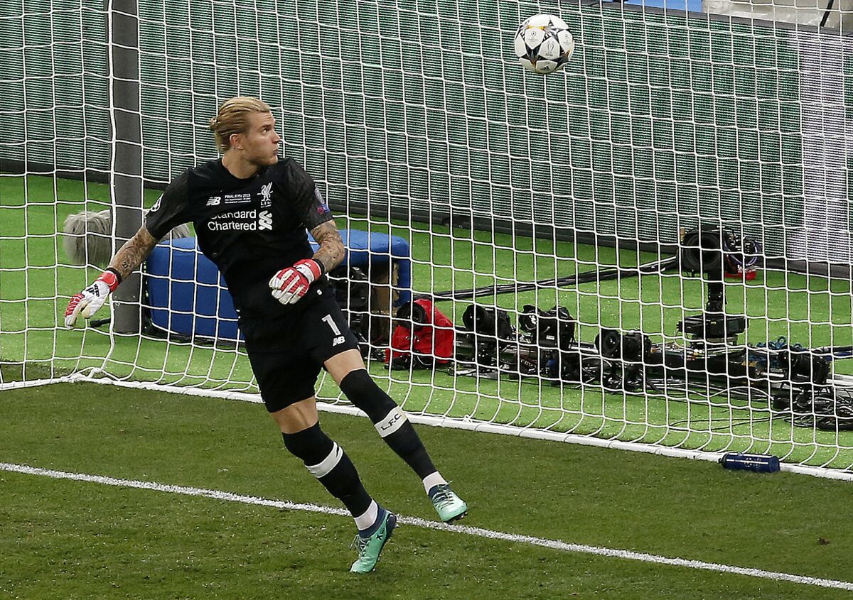 FILE - Liverpool goalkeeper Loris Karius looks at the ball after a fumble allowed Real Madrid's Gareth Bale to score his side's 3rd goal during the Champions League Final soccer match between Real Madrid and Liverpool at the Olimpiyskiy Stadium in Kiev, Ukraine, May 26, 2018. Liverpool has confirmed the departure of goalkeeper Loris Karius four years after his last appearance for the club when his concussion-related gaffes contributed to a 3-1 loss to Real Madrid in the 2018 Champions League final. (AP Photo/Darko Vojinovic, File)