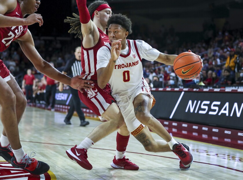 USC guard Boogie Ellis drives past Washington State guard Tyrell Roberts in the second half of USC's 60-62 win Sunday.