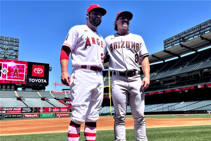 Brothers David Fletcher and Dominic Fletcher stand beside each other at Angel Stadium