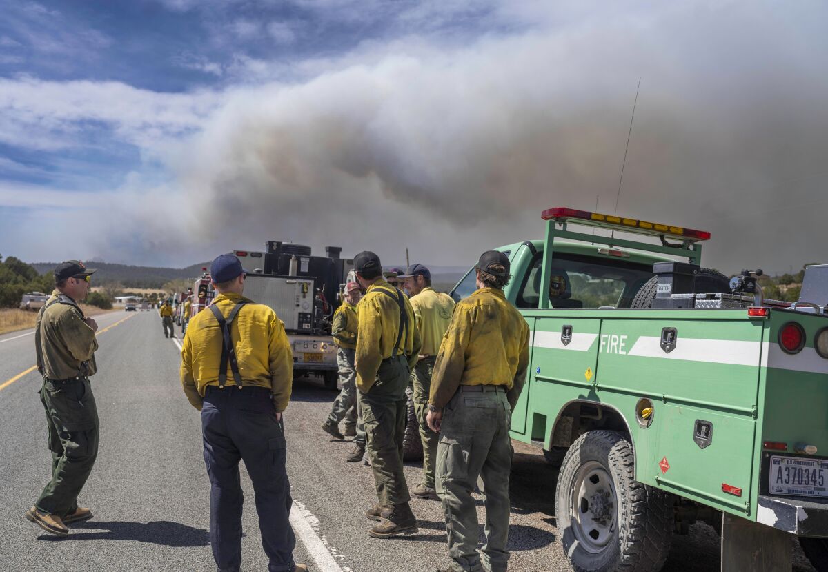 Wildland firefighters from several agencies throughout the country wait along state road 283 to be sent into the Hermits Peak and Calf Canyon Fires burning just west of Las Vegas, N.M. (Roberto E. Rosales/Albuquerque Journal)