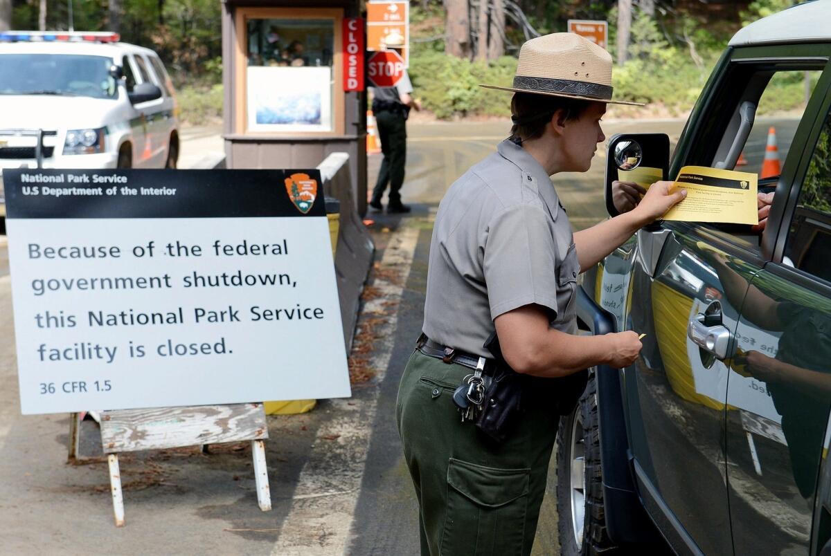 U.S. park ranger Heidi Schlichting informs visitors in of the closure of Yosemite National Park due to the government shutdown in October 2013.
