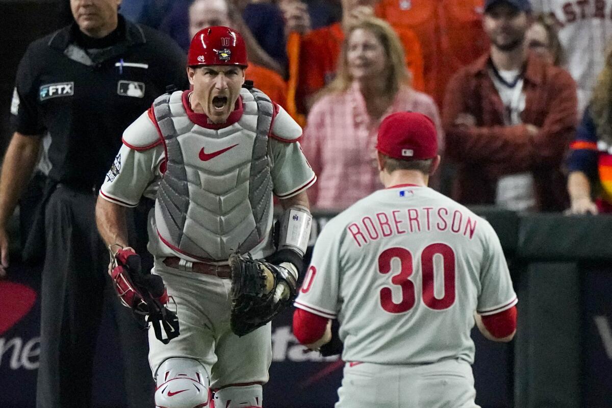 Philadelphia Phillies relief pitcher David Robertson and catcher J.T. Realmuto celebrate after their win against the Houston Astros in Game 1 of baseball's World Series between the Houston Astros and the Philadelphia Phillies on Friday, Oct. 28, 2022, in Houston. The Phillies won 6-5 to take a one game lead in the series. (AP Photo/Sue Ogrocki)