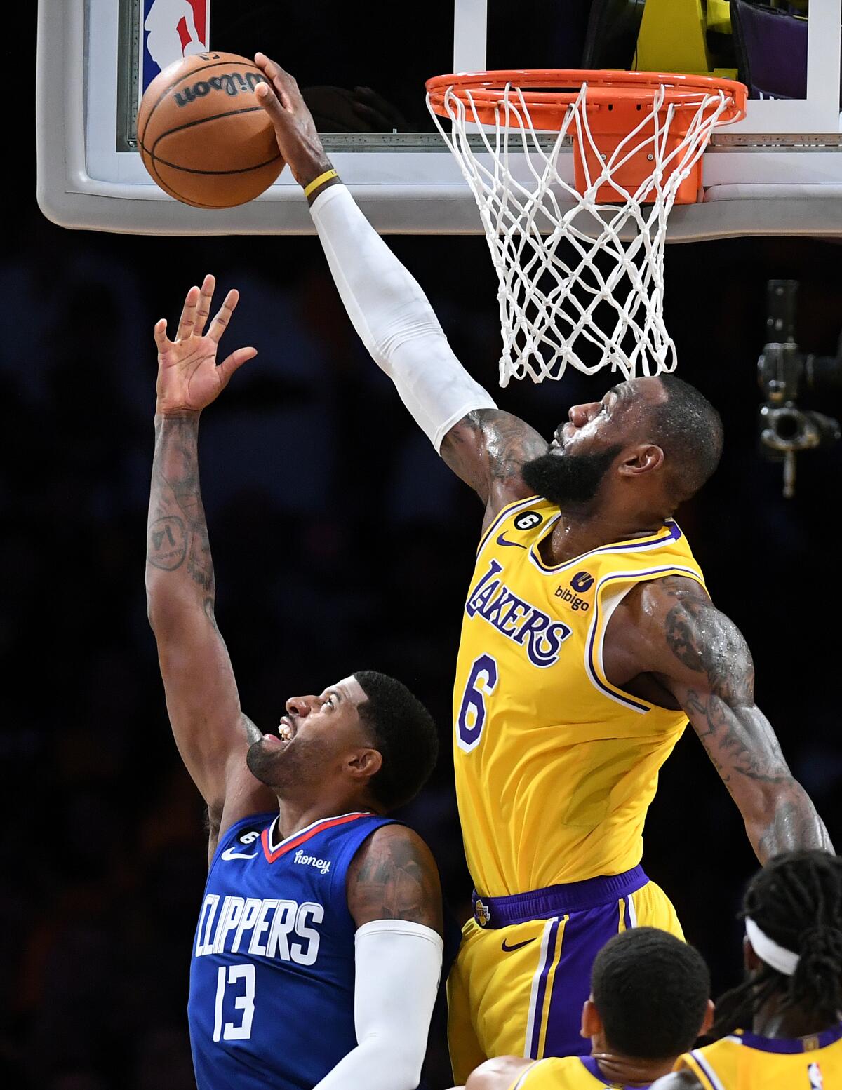 Lakers forward LeBron James blocks the shot of Clippers forward Paul George.
