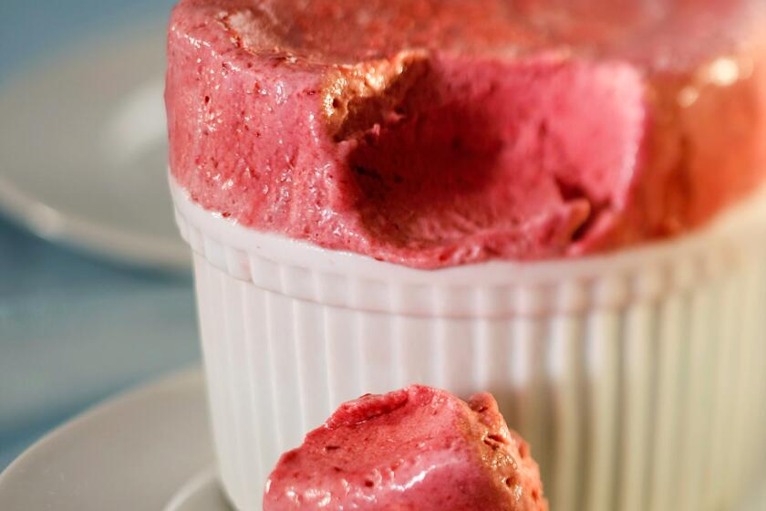 A pink dessert in a white ramekin