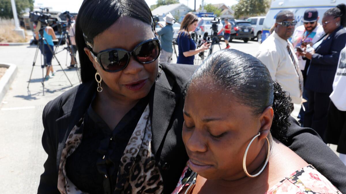 The mother of Clinton Alford Jr., Valerie Washington, and older sister, Lashaya Johnson, grow emotional Monday as they speak to reporters about the newly released video of Alford's 2014 arrest by the L.A. Police Department, which shows an officer kicking and punching the man.