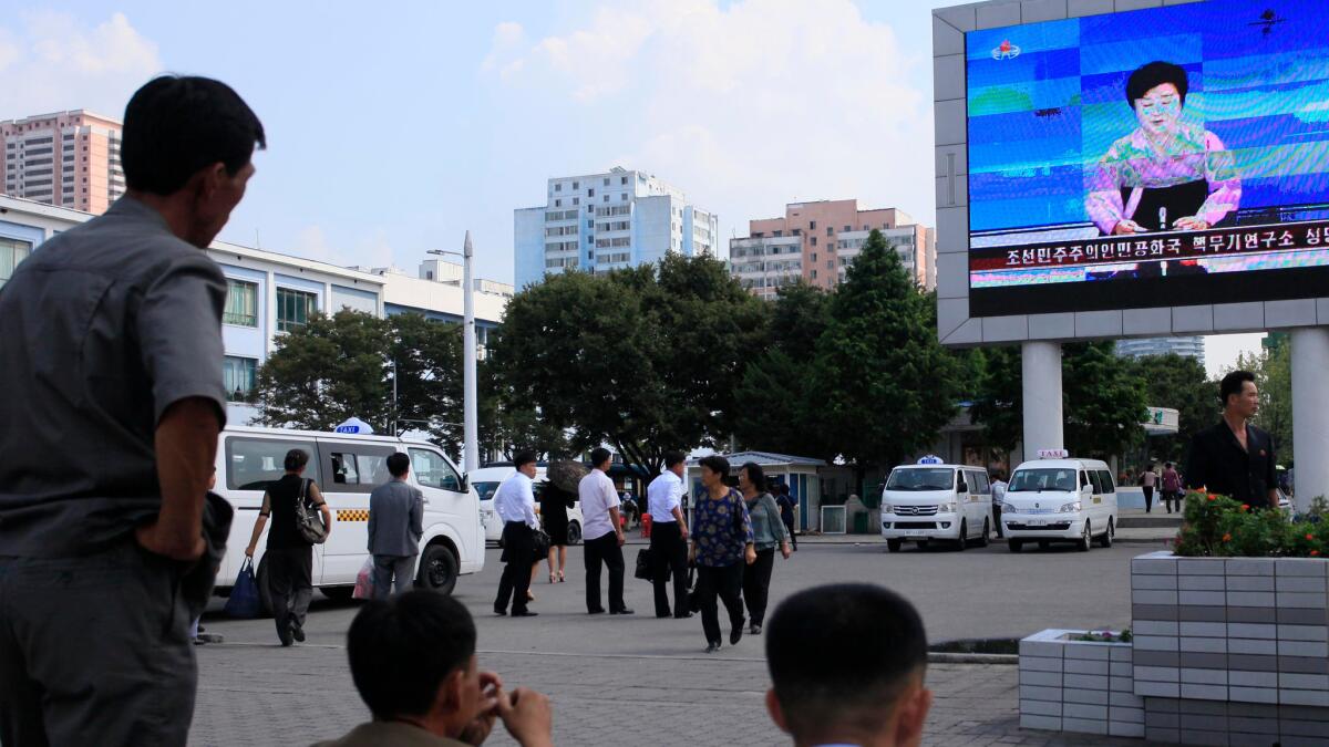 North Koreans watch a news report announcing a nuclear test in Pyongyang on Sept. 9.