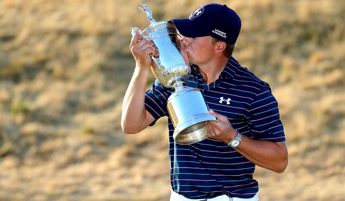 Jordan Spieth kisses the trophy after winning the 115th U.S. Open Championship at Chambers Bay on Sunday. He becomes the sixth golfer to win the U.S. Open and The Masters the same year.