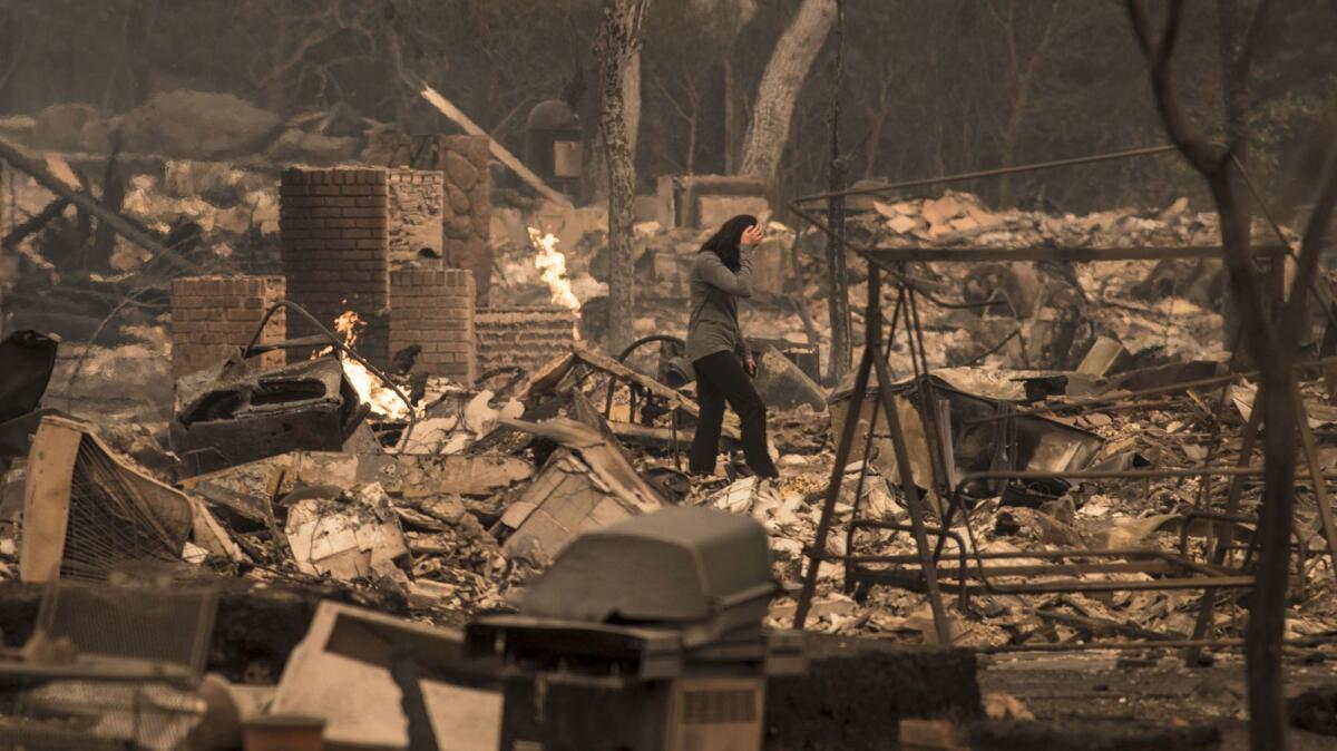 A Fountaingrove Village homeowner surveys her destroyed home she and her husband have owned for 4 years in Santa Rosa.