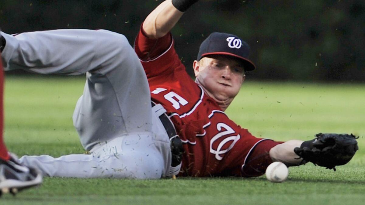 Washington Nationals center fielder Nate McLouth fails to make a catch during a game against the Chicago Cubs in June. A shoulder injury will sideline McLouth for the remainder of the season.