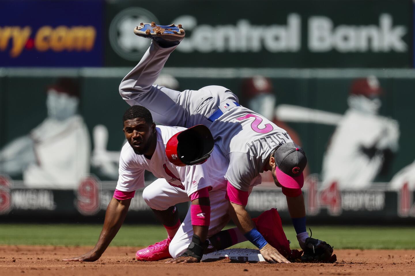 The Cardinals' Dexter Fowler, bottom, takes out the Cubs' Tommy La Stella, top, after he turns a double play during the first inning Saturday, May 13, 2017, in St. Louis.