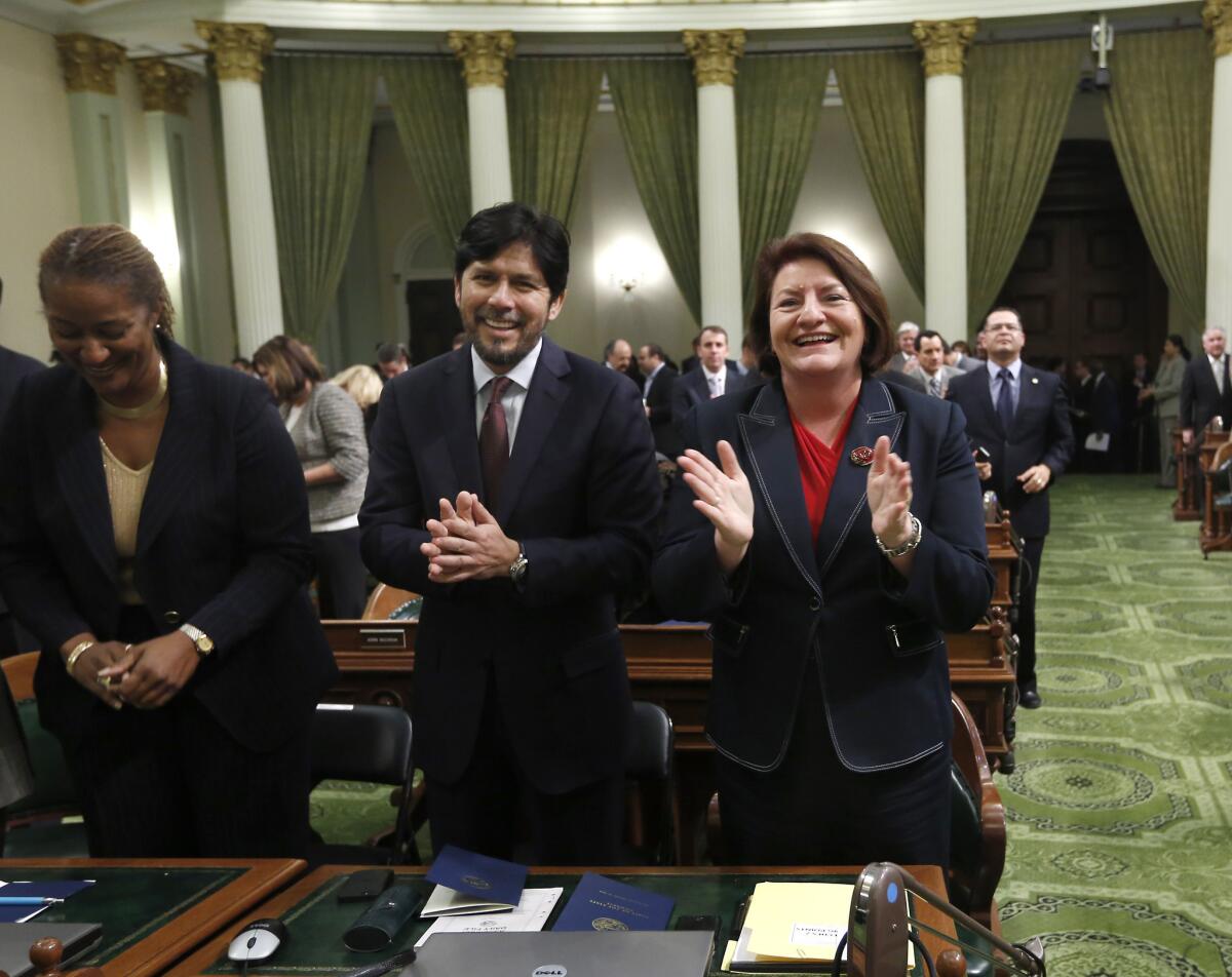 Sen. Kevin de Leon (D-Los Angeles) and Assemblywoman Toni Atkins (D-San Diego) applaud Gov. Jerry Brown, before his annual State of the State address in January of last year.