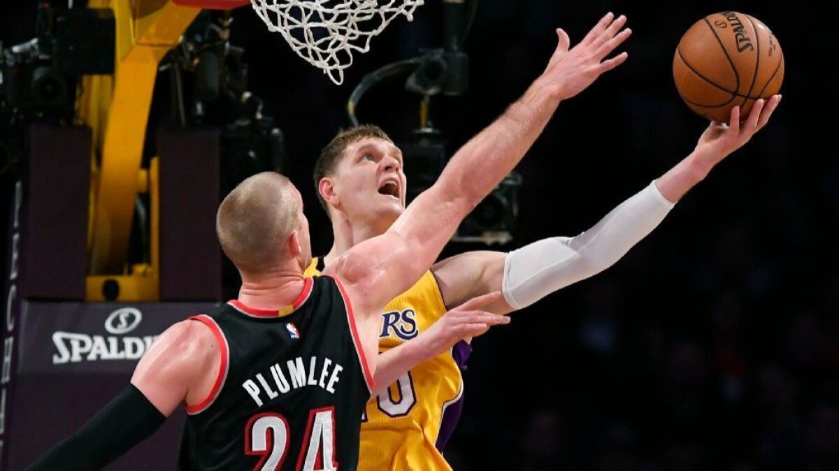 Lakers center Timofey Mozgov, right, shoots as Trail Blazers center Mason Plumlee defends during a game on Jan. 10.