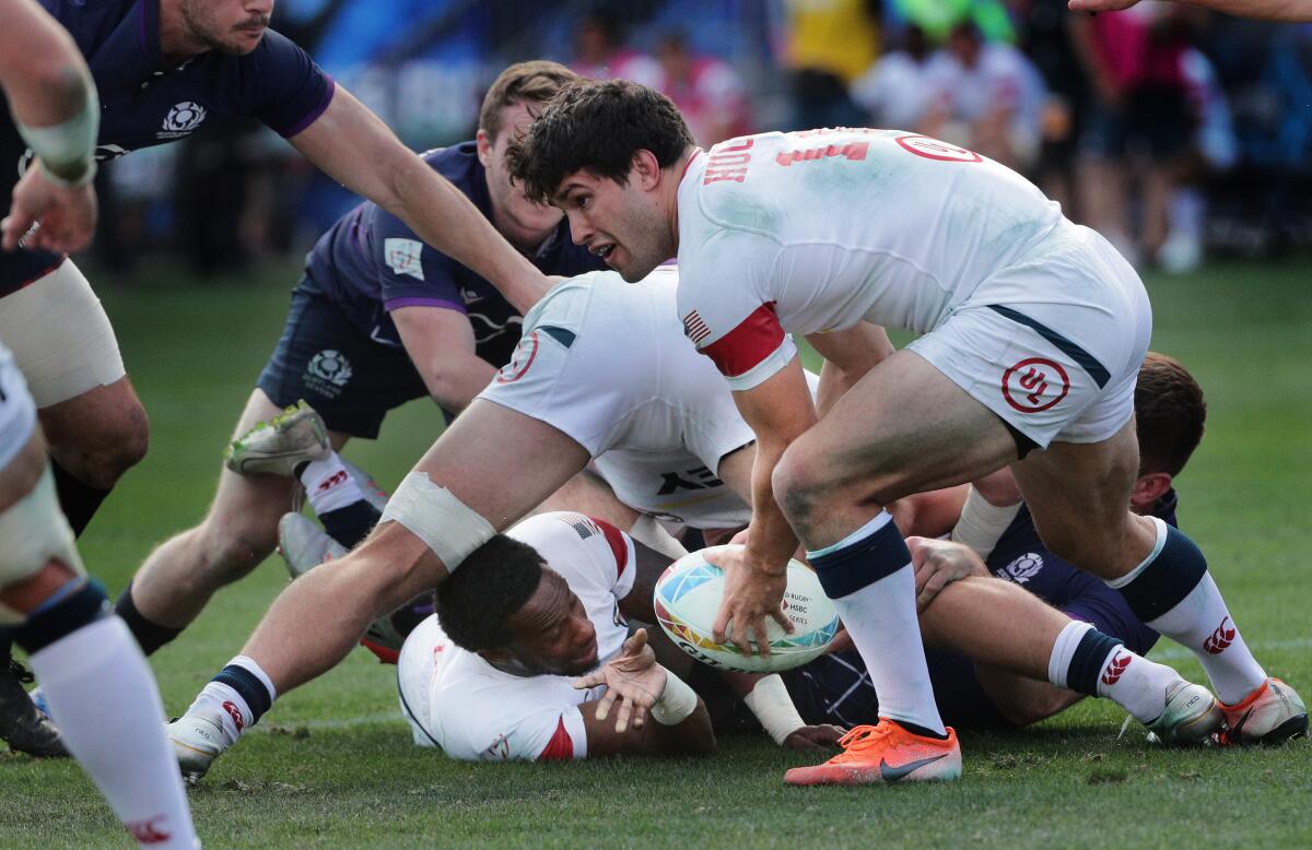 USA 7s Carlin Isles passes the ball to Madison Hughes (10) out of the scrum against Scotland 7s during a match Feb. 29, 2020, at the HSBC World Rugby Sevens tournament in Carson.