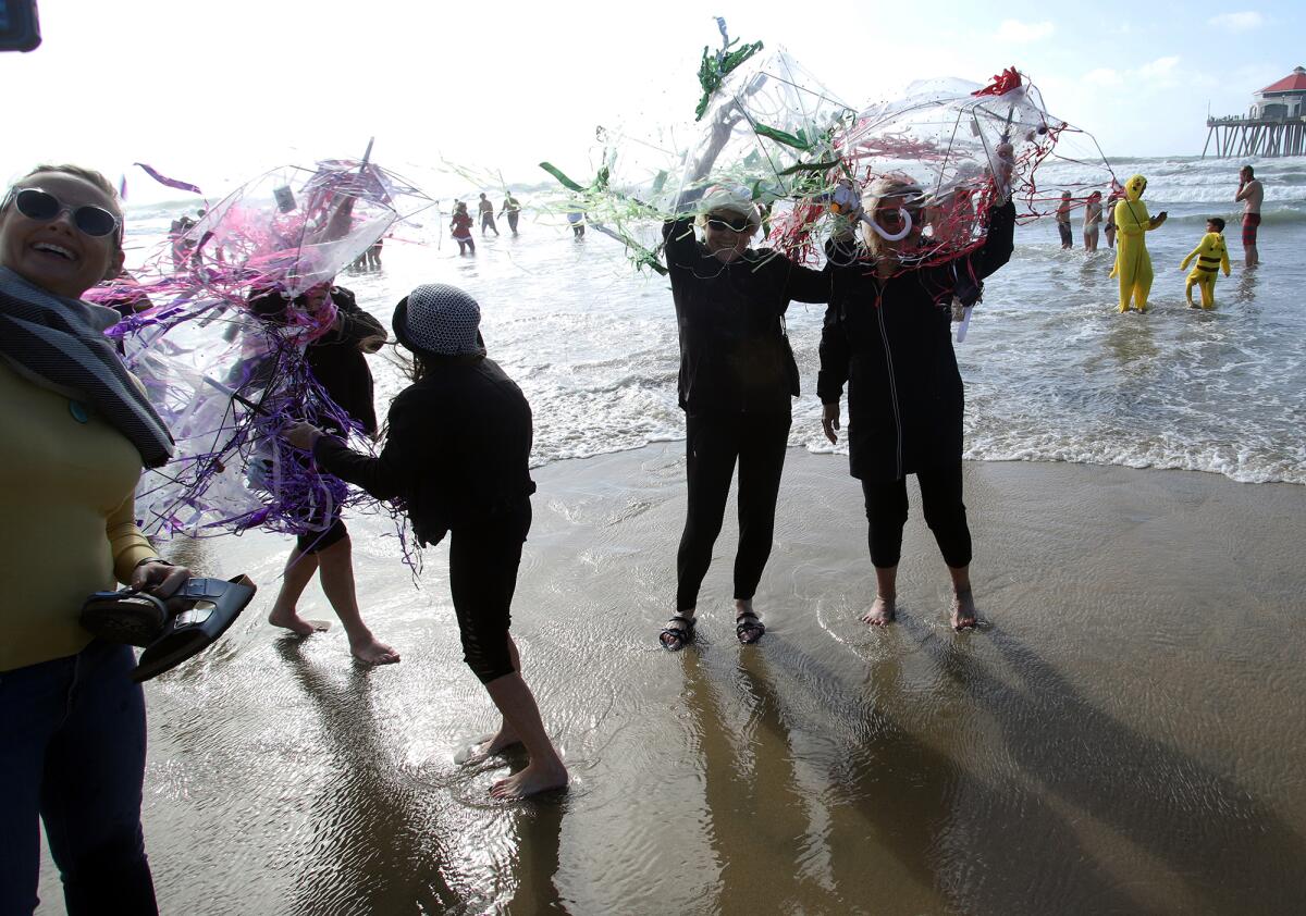 The "jellyfish" ladies and others wearing costumes have fun as they dip their feet into the chilly Pacific Ocean Sunday.