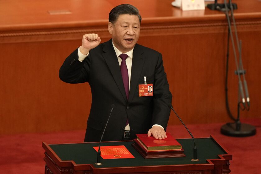 Chinese President Xi Jinping takes his oath after he is unanimously elected as President during a session of China's National People's Congress (NPC) at the Great Hall of the People in Beijing, Friday, March 10, 2023. Chinese leader Xi Jinping was awarded a third five-year term as president on Friday, putting him on track to stay in power for life. (AP Photo/Mark Schiefelbein)