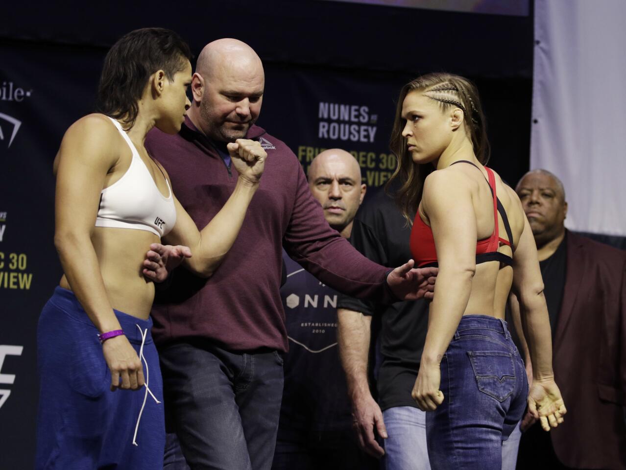 Ronda Rousey, right, and Amanda Nunes face off for photographers during an event for UFC 207, Thursday, Dec. 29, 2016, in Las Vegas. Rousey is scheduled to fight Nunes in a mixed martial arts women's bantamweight championship bout Saturday in Las Vegas. (AP Photo/John Locher)