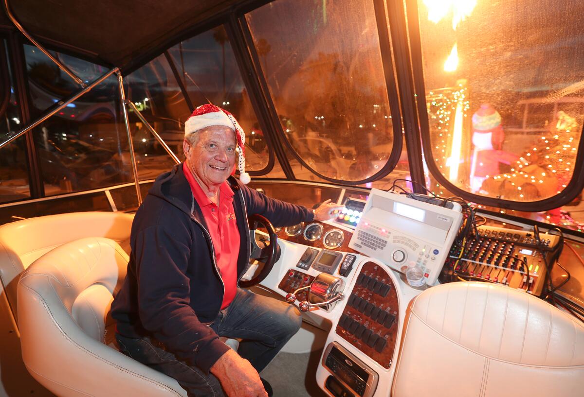 Greg Killingsworth sits in the captain's chair as he adjusts lighting on the boat.